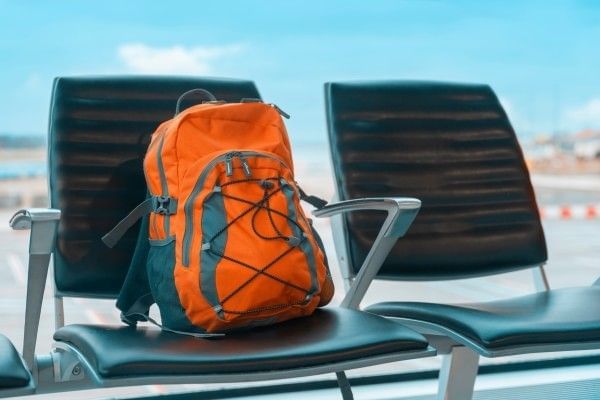 Orange backpack on a chair at the airport