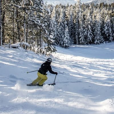 a skier making their way down a ski run