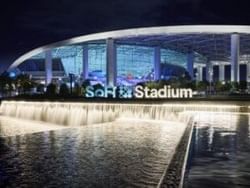 Outside Sofi Stadium in Los Angeles CA during evening hours including the lake in front of stadium