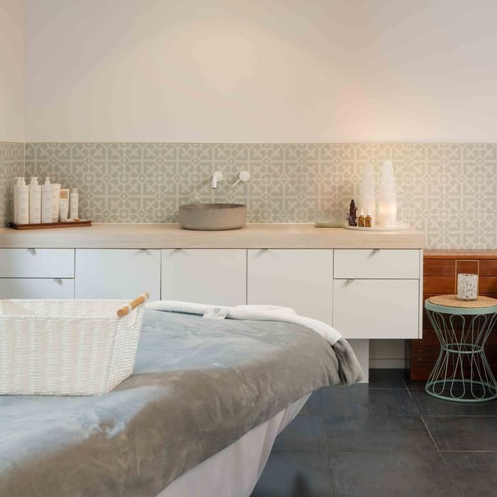 Wildfire Day Spa with decorative tiles, skincare products, and a massage table at Mercure Kooindah Waters