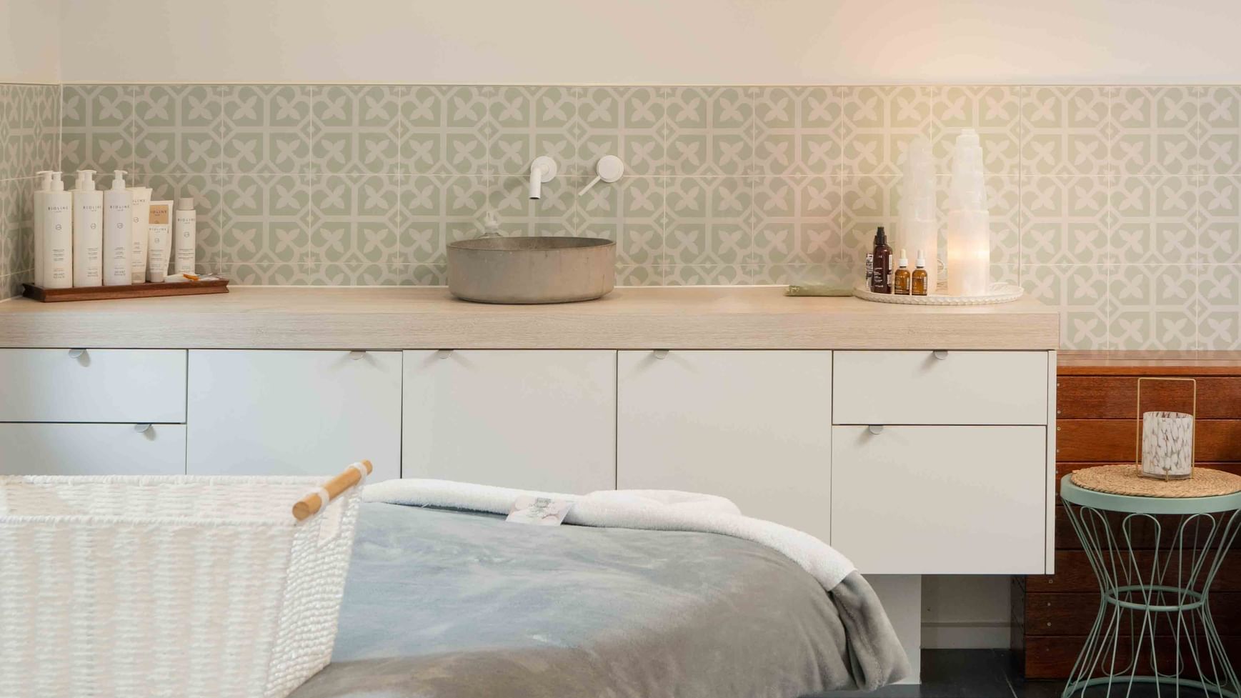 Wildfire Day Spa with decorative tiles, skincare products, and a massage table at Mercure Kooindah Waters