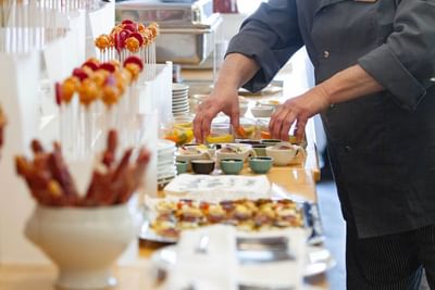 Chef preparing appetizer on a counter at Müggelseeperle Hotel