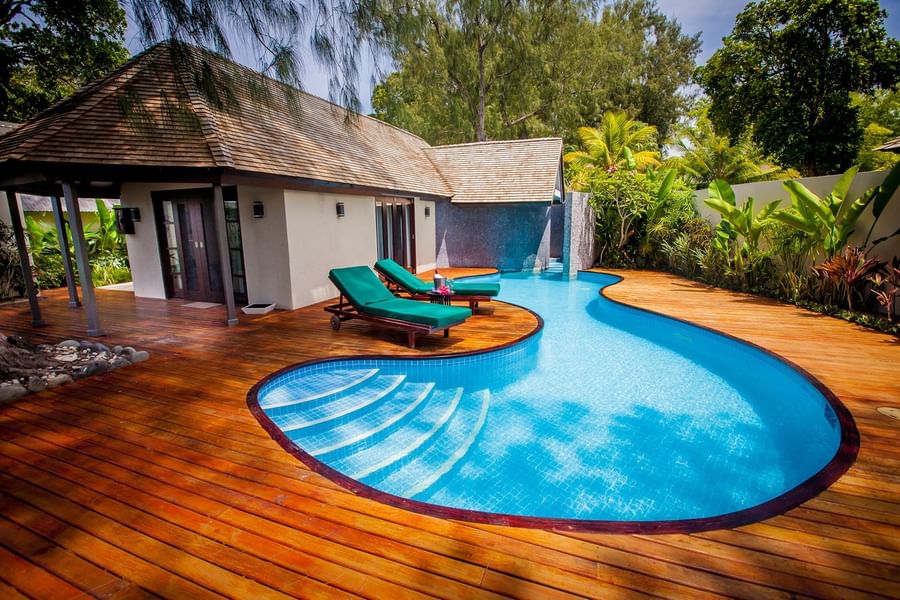 Efate Pool Villa with a bright blue swimming pool and sun loungers on a deck at warwick le lagon-vanuatu 