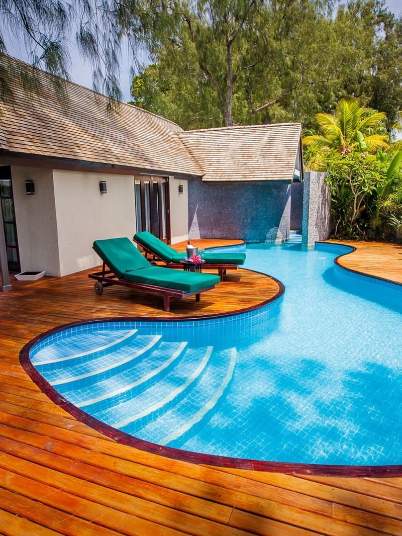 Efate Pool Villa with a bright blue swimming pool and sun loungers on a deck at warwick le lagon-vanuatu 