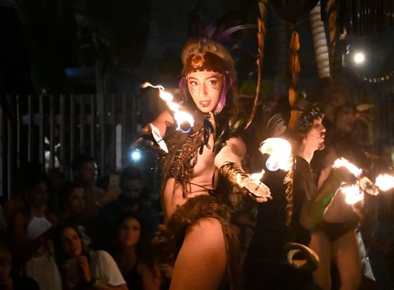 Woman in tribal costume fire dancing at Boulan South Beach