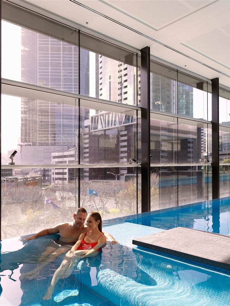 Couple enjoying in an indoor pool at Crown Hotel Melbourne