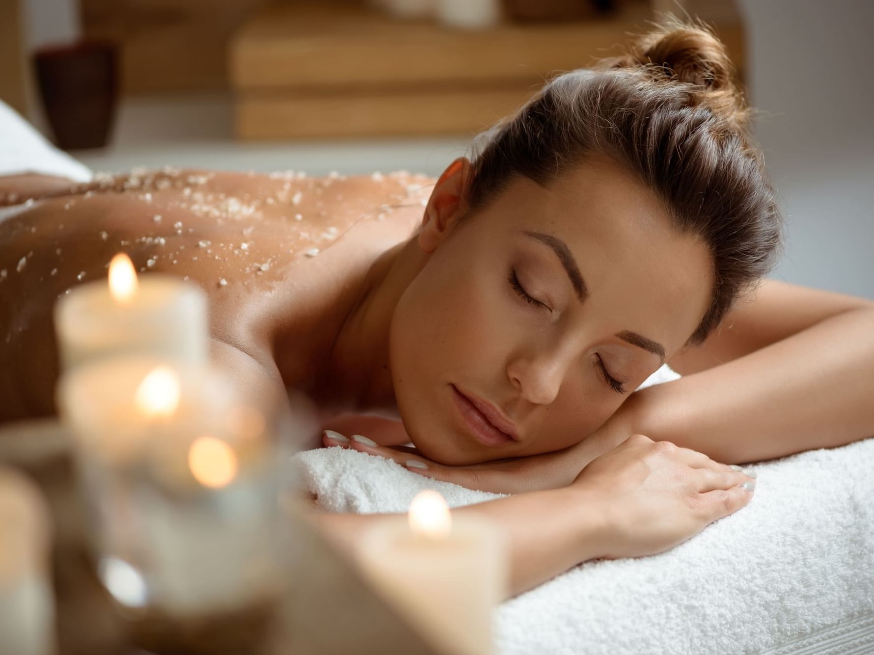 Lady relaxing on a massage bed in spa at Hotel Factory Green