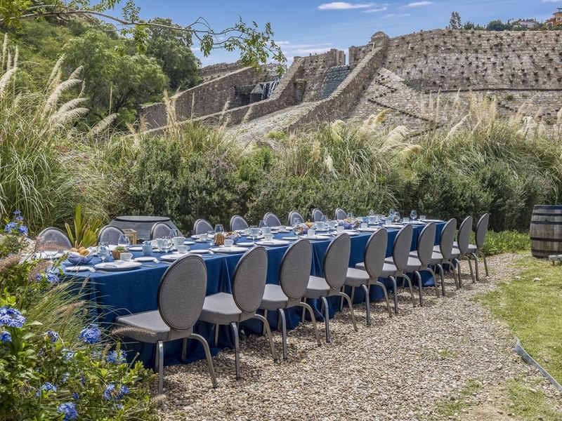 Outdoor royal banquet table set up in the Botanical Garden at Live Aqua San Miguel de Allende
