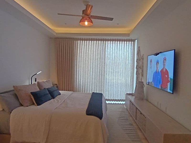 King bed and smart TV in a room at Live Aqua Private Residences La Paz