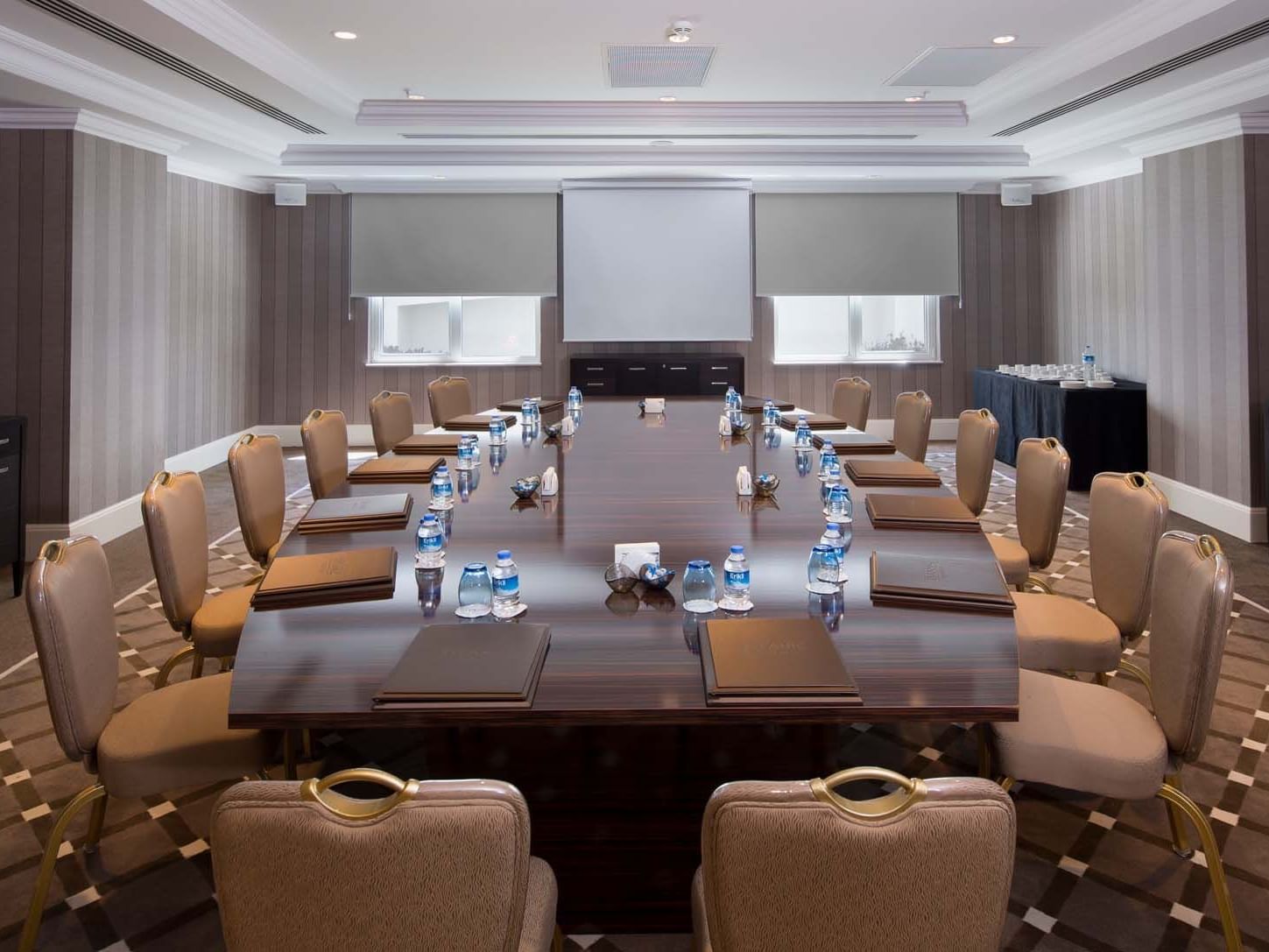 Boardroom setup with projector screen in Marmara Meeting Rooms at Titanic Deluxe Golf Belek