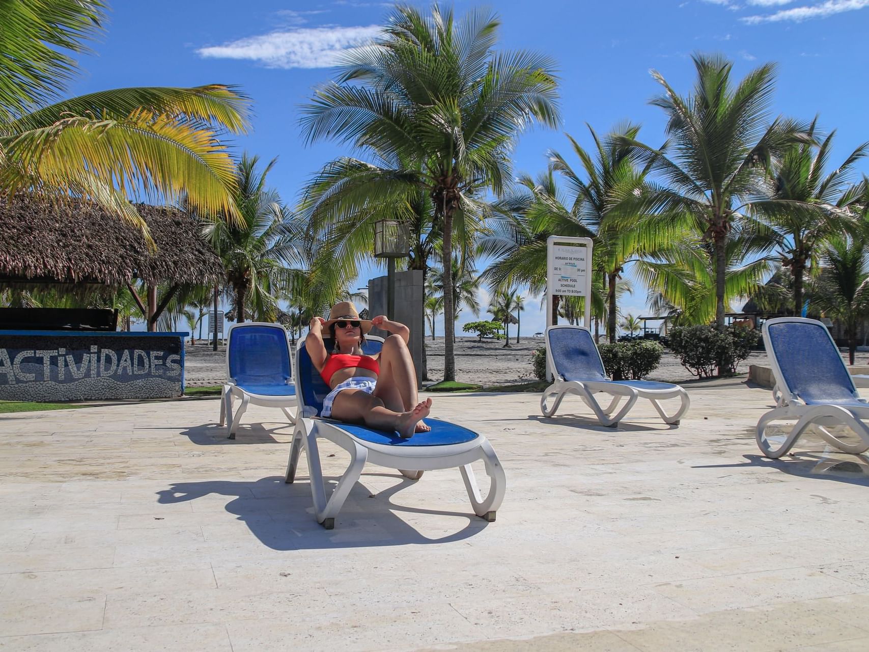 Lady relaxing on a sunbed by beach at Playa Blanca Beach Resort