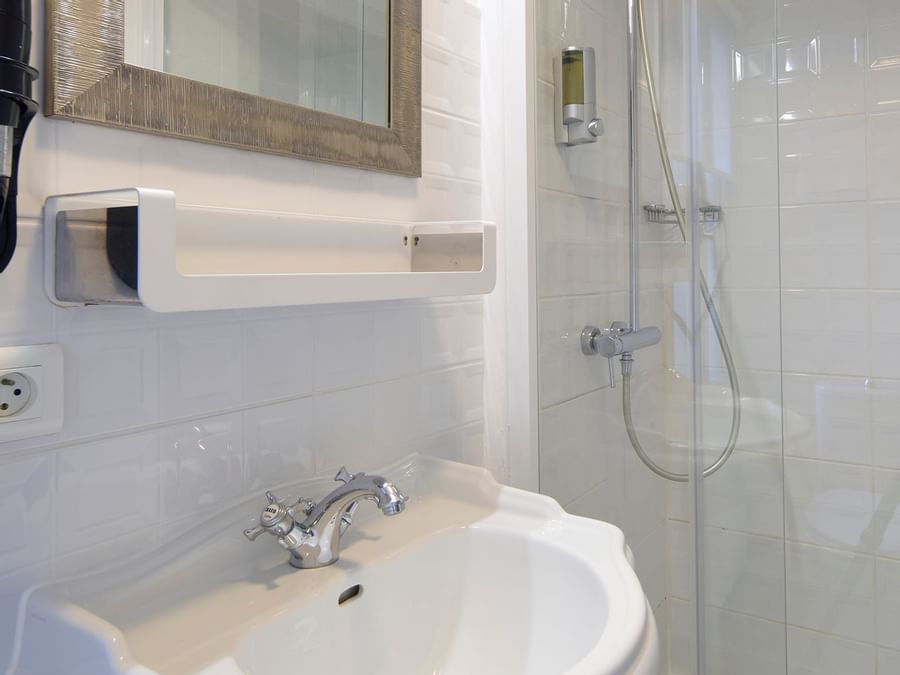 Washbasin, mirror & shower at The Originals Hotels