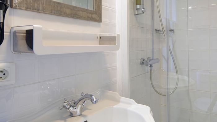 Washbasin, mirror & shower at The Originals Hotels
