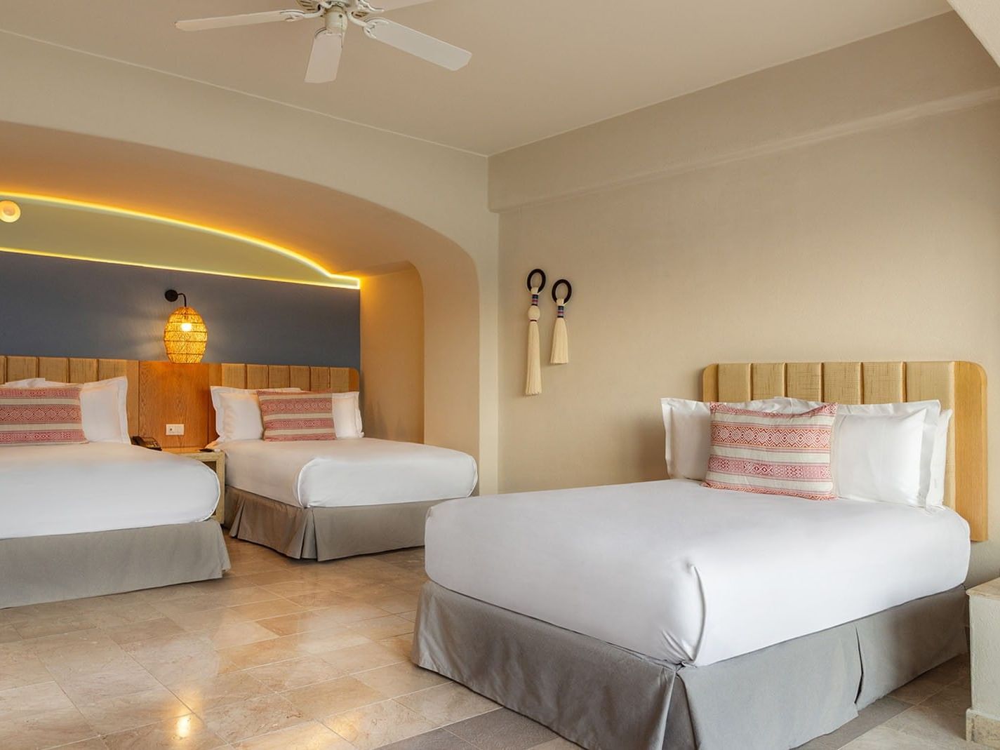Three Double Beds Deluxe Superior Room featuring two beds, a blue wall, and woven wall decor at Camino Real Acapulco Diamante