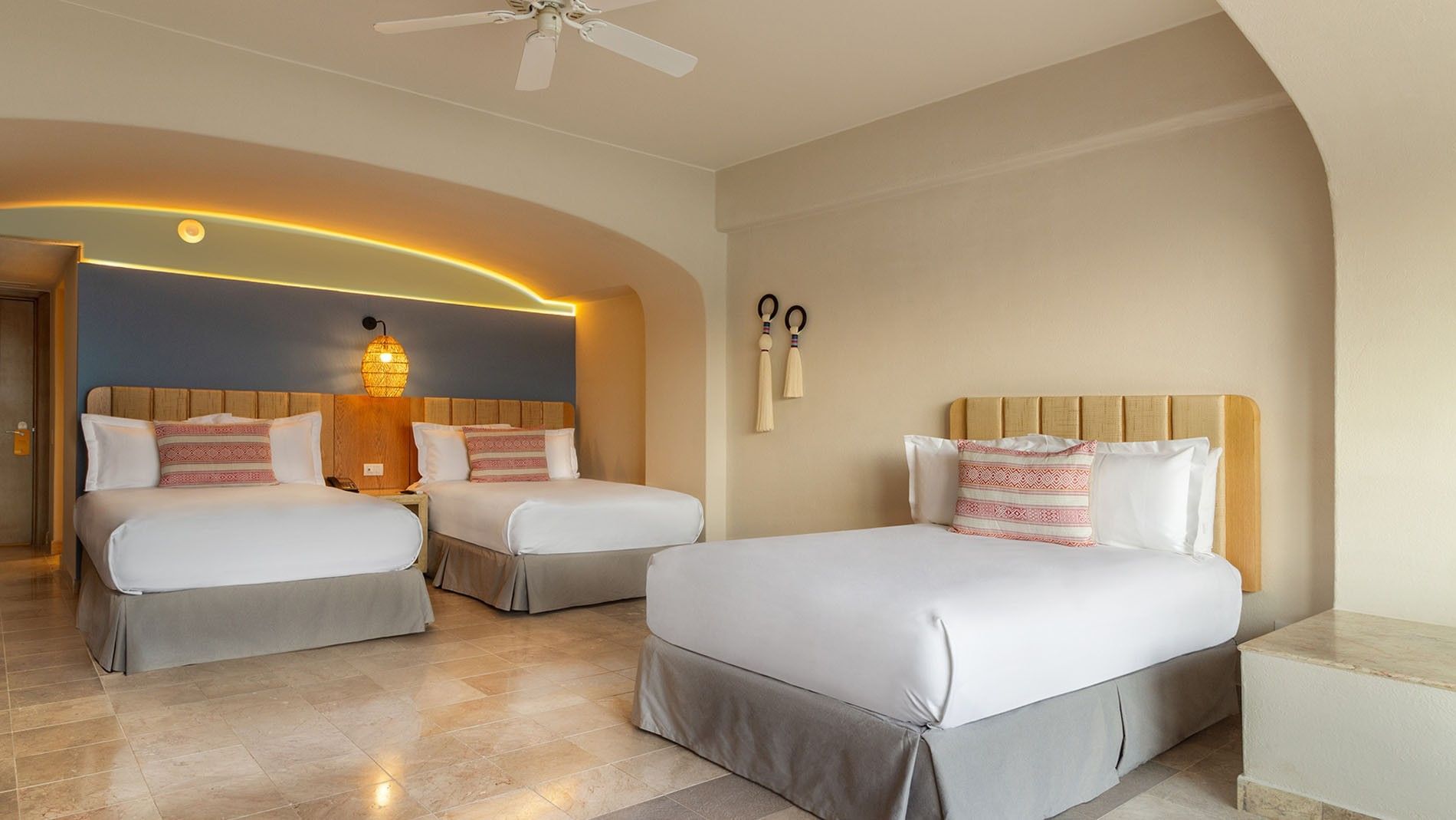 Three Double Beds Deluxe Superior Room featuring two beds, a blue wall, and woven wall decor at Camino Real Acapulco Diamante