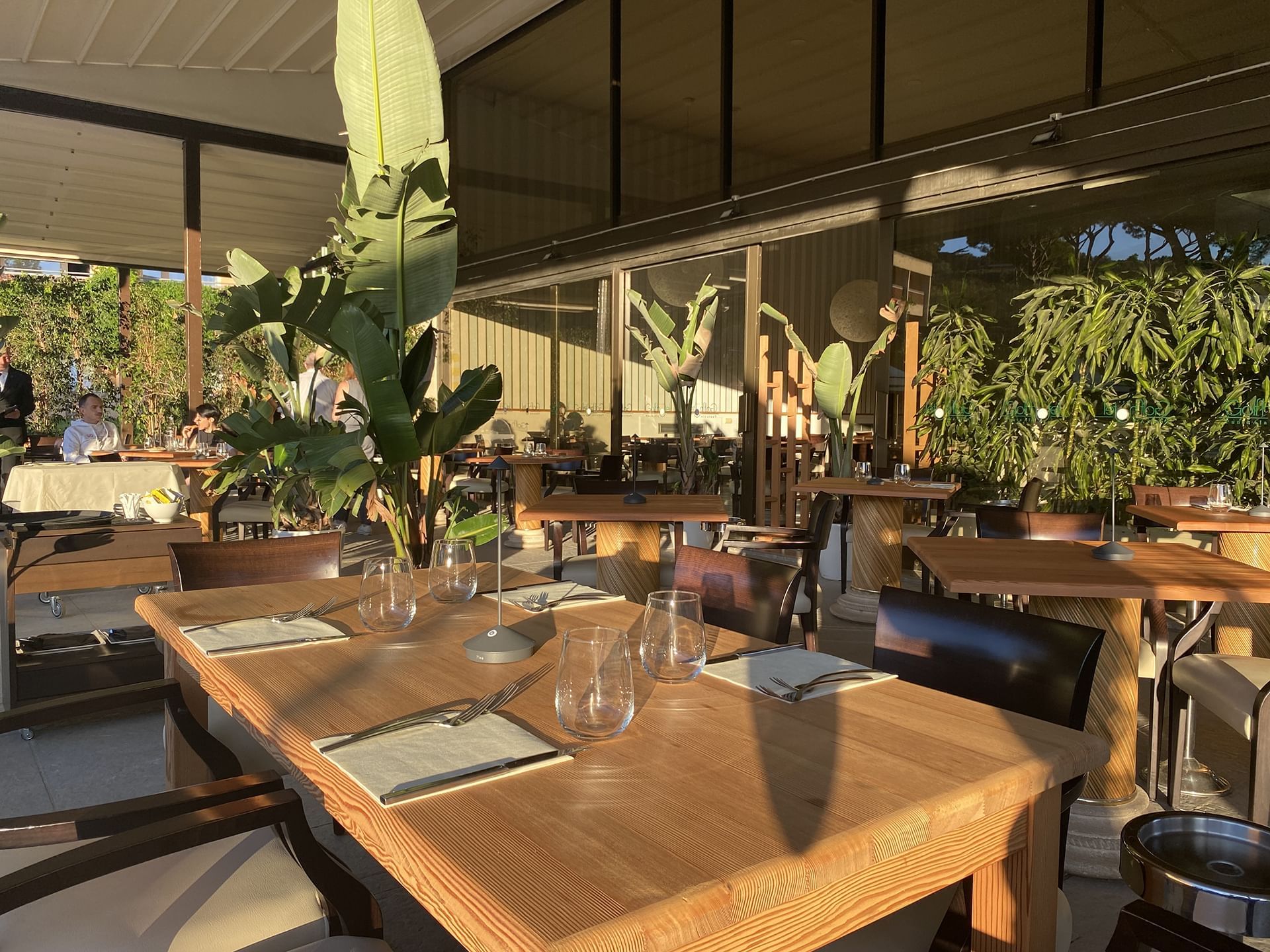 Dining table arranged in Patio Pool Bar & Restaurant at Golf Hotel Punta Ala