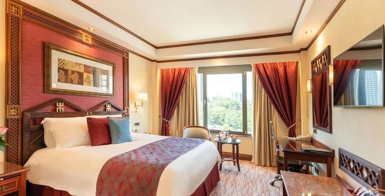 Queen Bed & furniture in Deluxe Room at Nairobi Serena Hotel