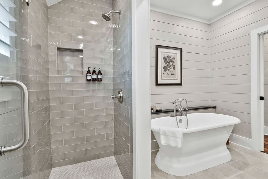 Modern Deluxe King Cottage bathroom with glass shower, bathtub, and minimalist decor by Cottages at Laurel Brooke