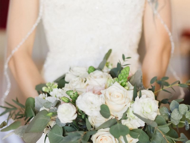 Close-up of bride holding a flower bouquet at Grand Fiesta Americana