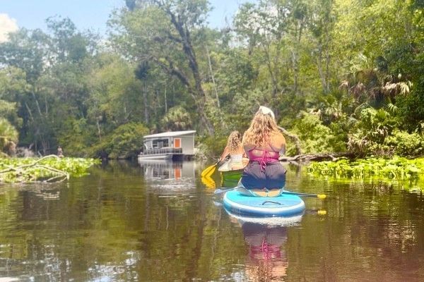 Two women paddleboard and kayak along the Wekiva River from Wekiva Island.