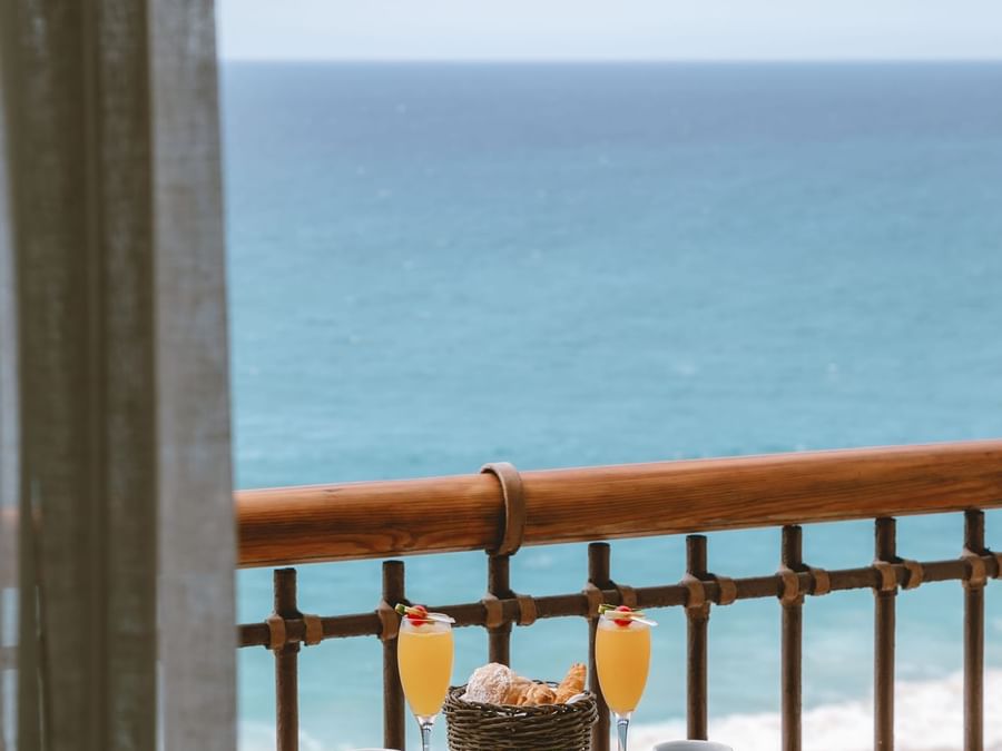 Ocean view from a private balcony in Junior Suite Ocean View at Marquis Los Cabos Resort with snacks and juices on table