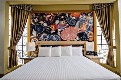 King bed in Ocean View Penthouse Suite with an Artistic Mural at Accra Beach Hotel & Spa