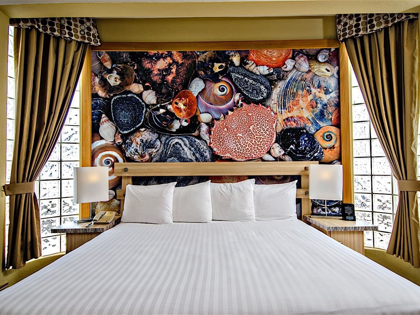 King bed in Ocean View Penthouse Suite with an Artistic Mural at Accra Beach Hotel & Spa