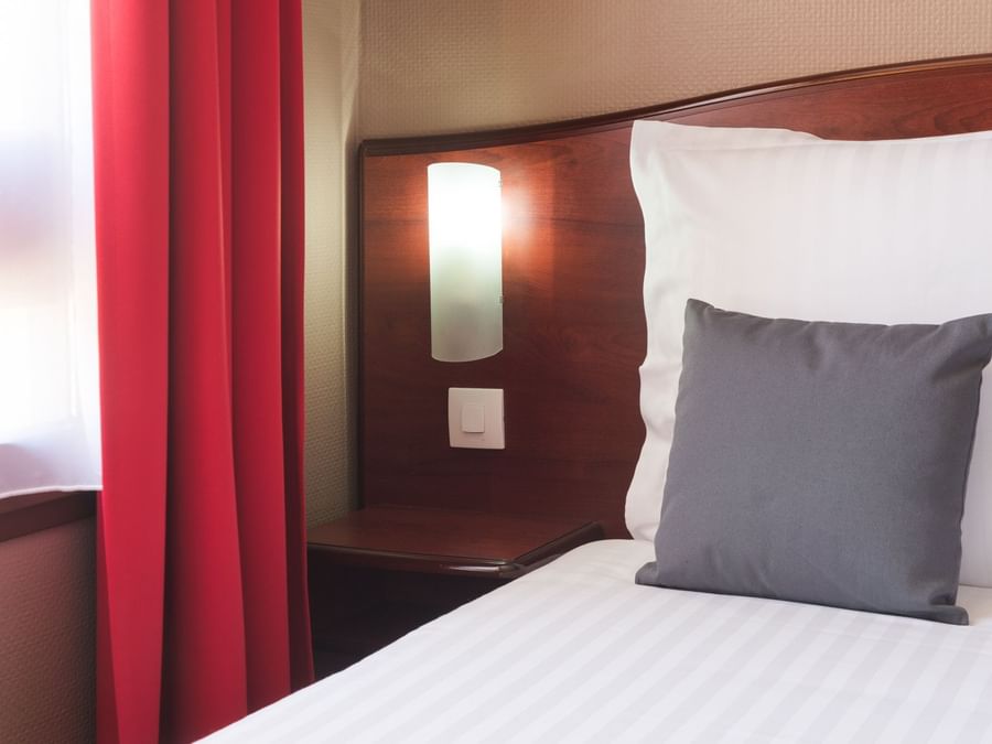 Closeup of bed in Hotel Arras bedroom at The Originals Hotel