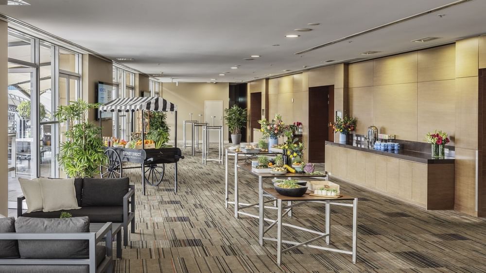 Pre-function area with a fruit cart and elegant tables of fresh food in Freshwater Balcony at Novotel Sydney Olympic Park