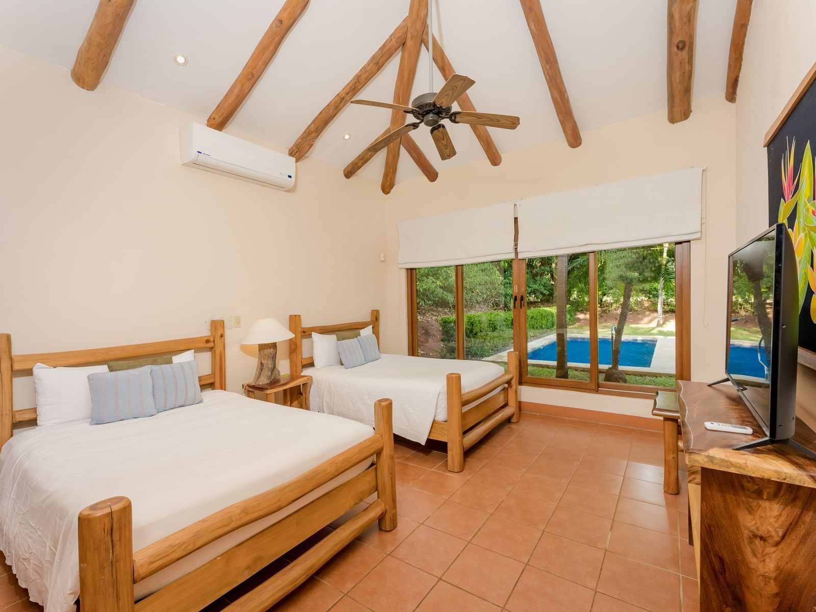 Two beds & a ceiling fan in Golf 2 Villa at Punta Islita Hotel