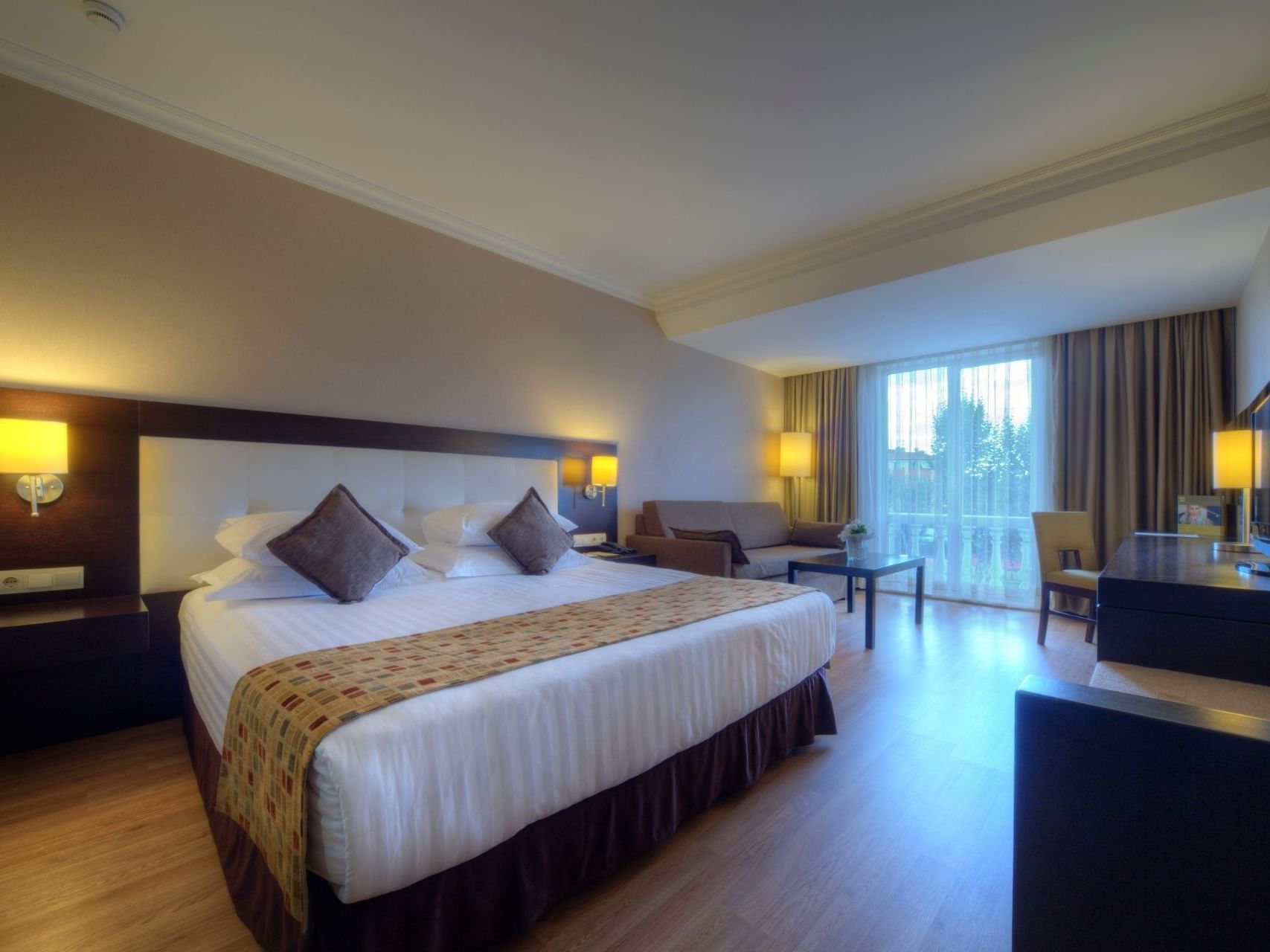 Elegant deluxe room at Eresin Hotels Topkapi with cozy bed and natural light.