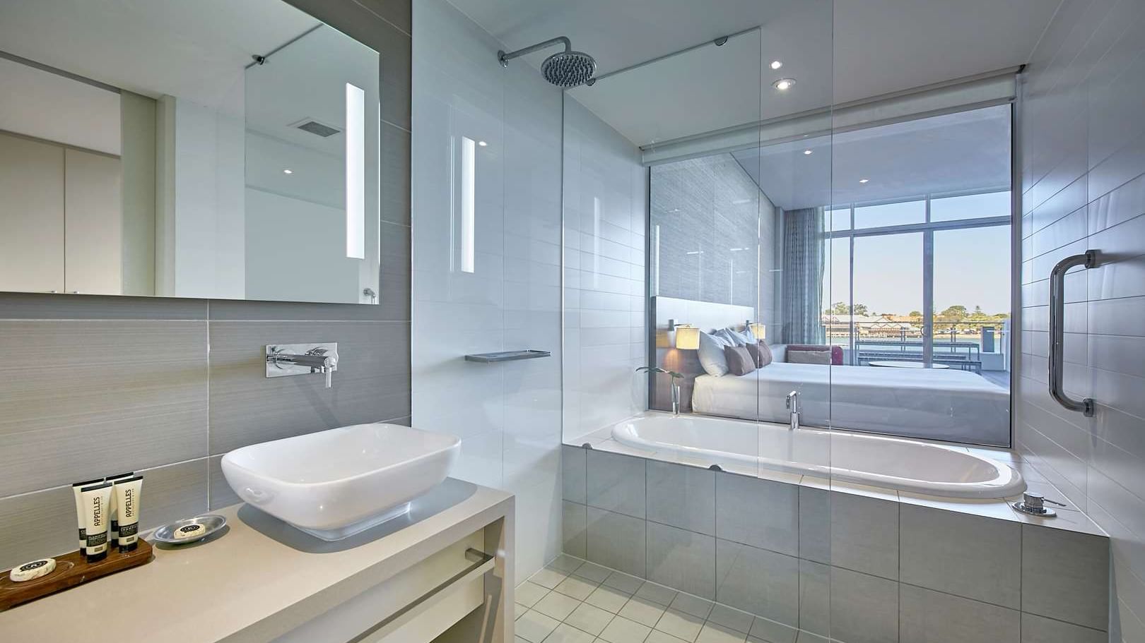 Modern Bath Bliss Room bathroom at The Sebel Mandurah with a tub and a large window into the bedroom