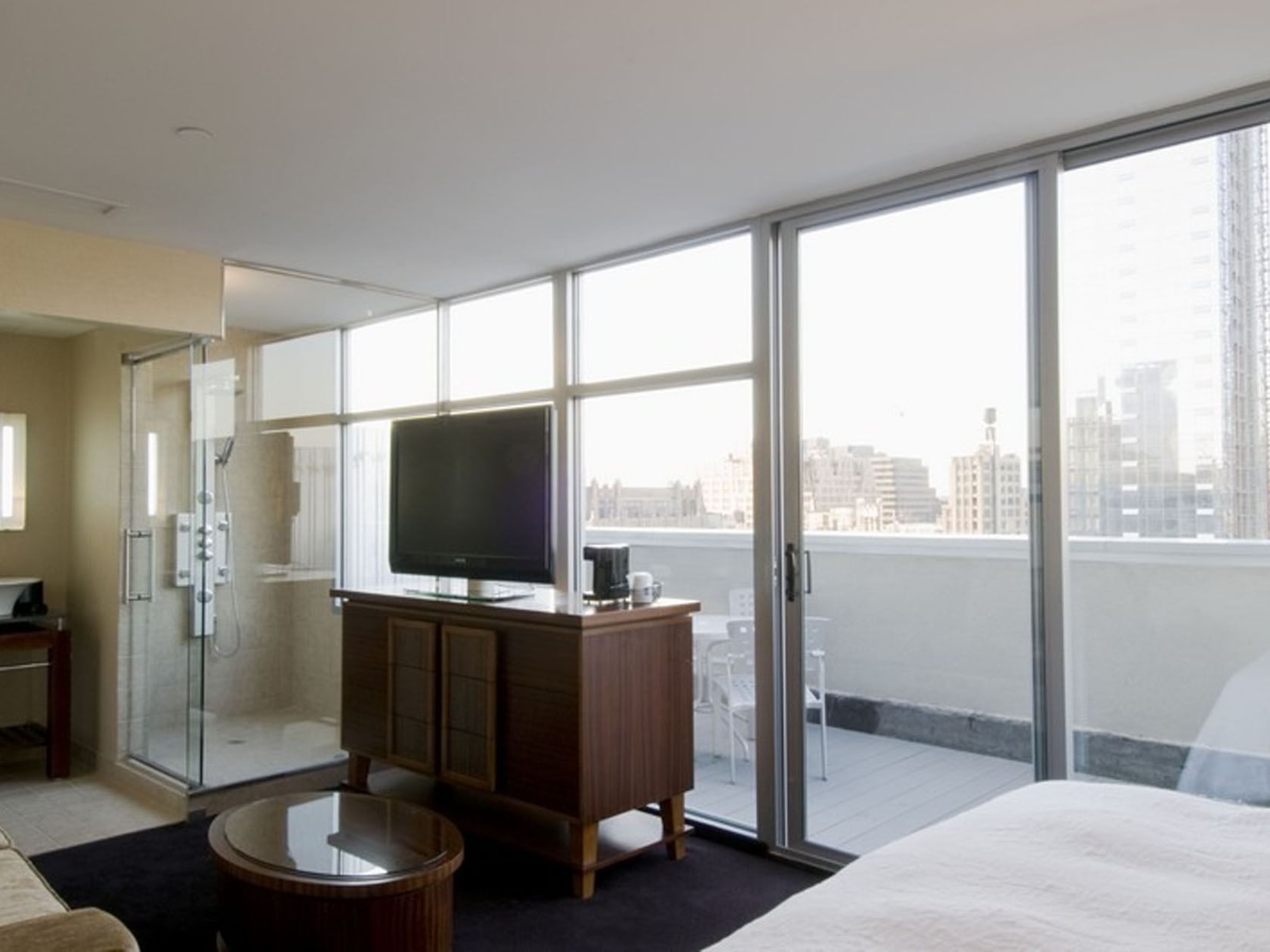 SoHo hotel room at Soho 54 in NYC, with open bathroom, private balcony, city views, featuring stay longer and save offer