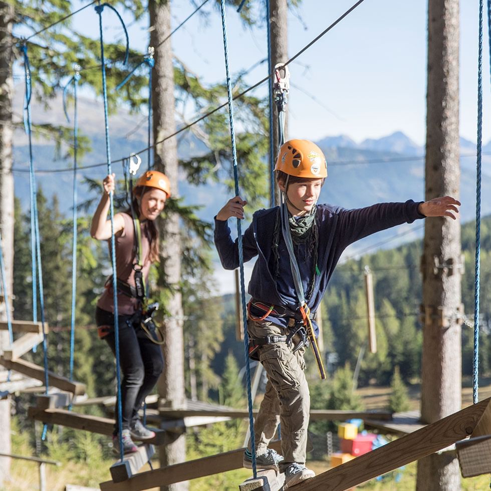 Kids engaged in high-wire course near Falkensteiner Hotels