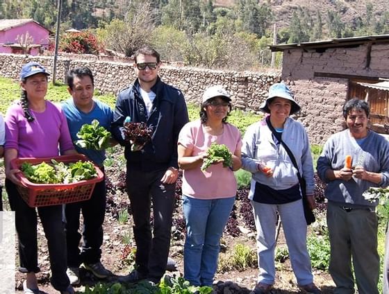 Tourists taking a picture with fresh harvest near Hotel Sumaq