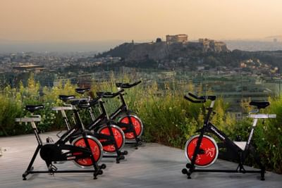 Exercise bikes by city view at St George Lycabettus
