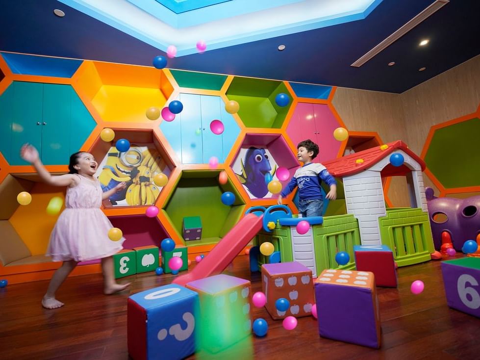2 children playing in colourful indoor playground
