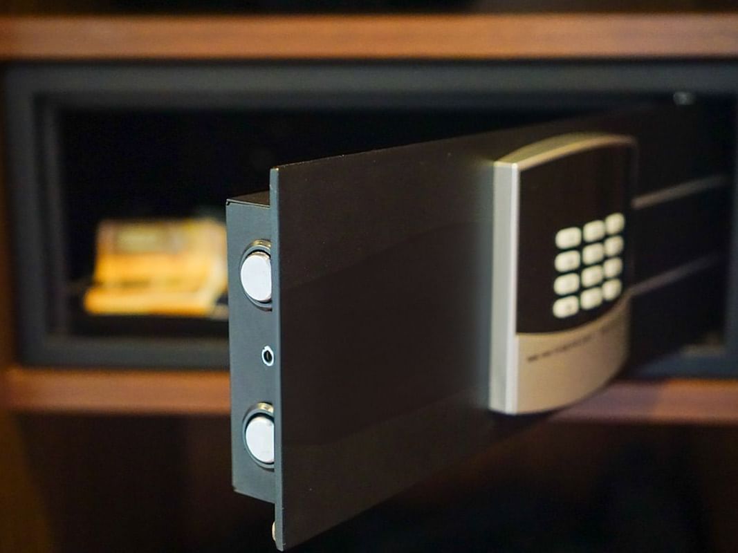 A partially open in-room safe reveals stored items at Paramount Hotel Portland for secure keeping of guest belongings