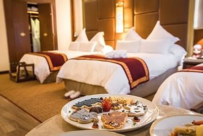 Interior of a family room with three beds at Hotel Sumaq