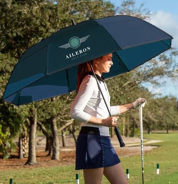 A girl having an umbrella in golf ground at Sunseeker Resort