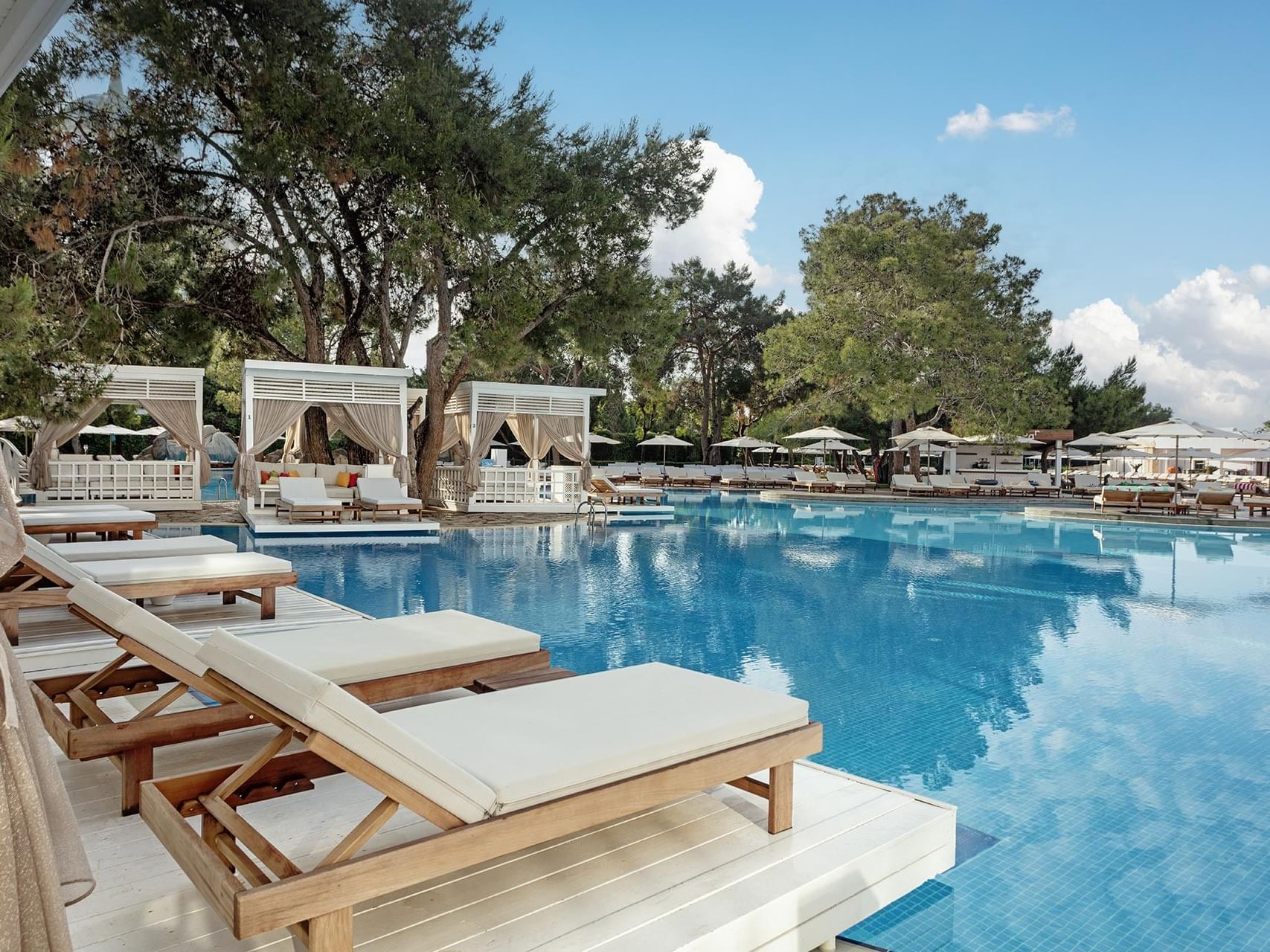 Sun lounger and pier huts by Lara Pool on a sunny day at Titanic Deluxe Lara