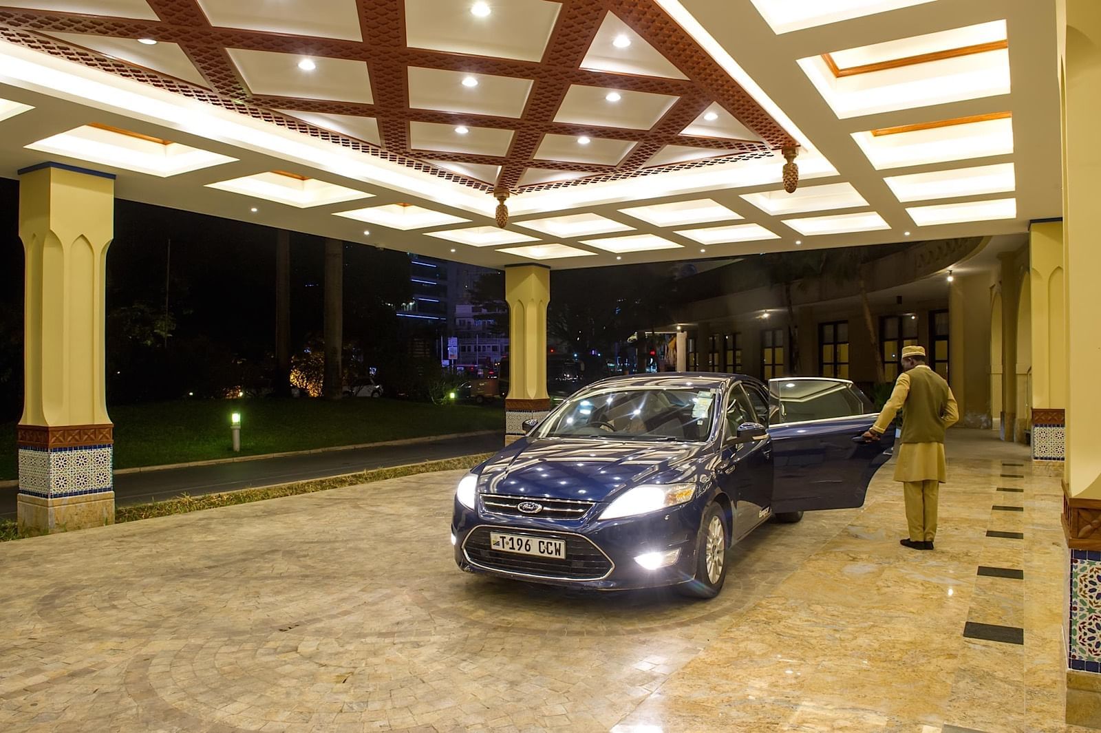 A Concierge opening the car door at Dar Es Saalam Serena Hotel