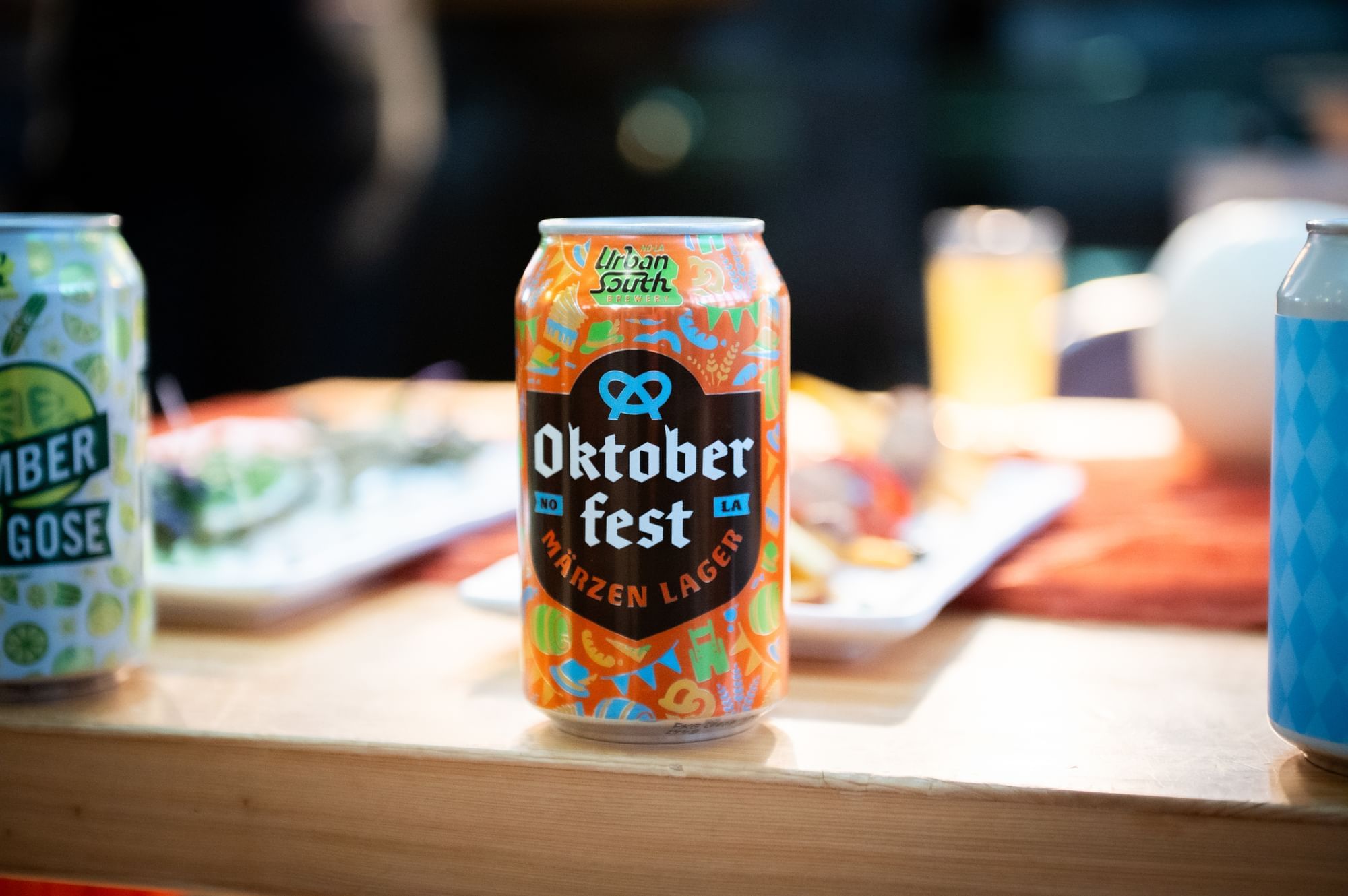 A brightly colored Oktoberfest beer can displayed on a bar top