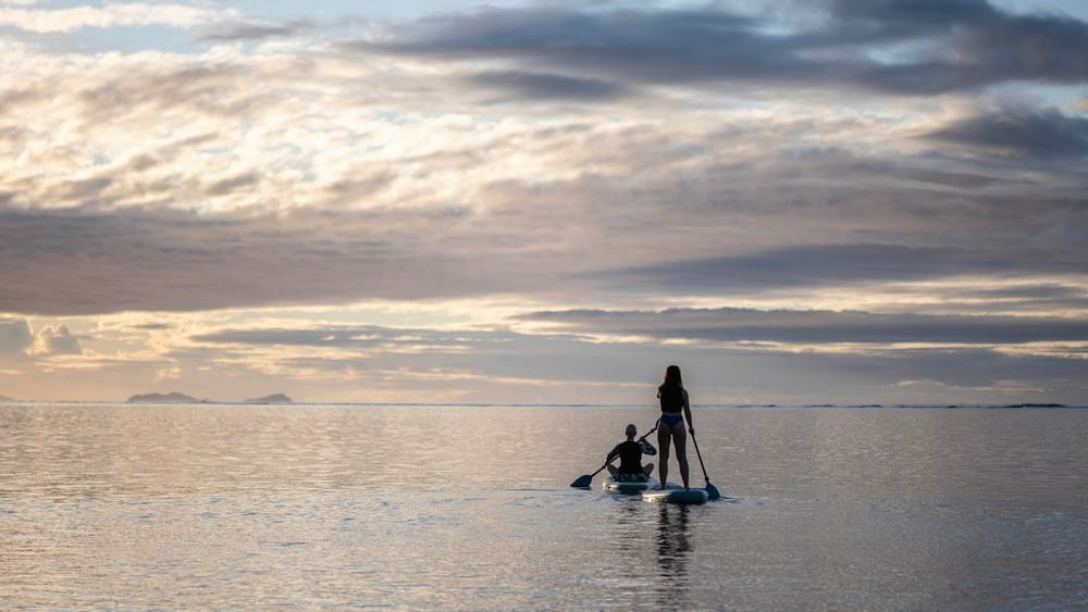 Two people on paddle boards at Warwick Fiji Resort and Spa in Korolevu.