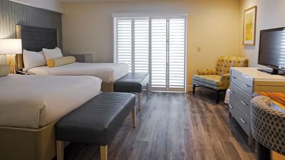 two beds and a tv in a hotel room