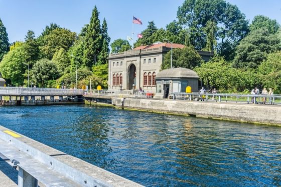 Historic Hiram M. Chittenden Locks by water surrounded by trees near Paramount Hotel Seattle