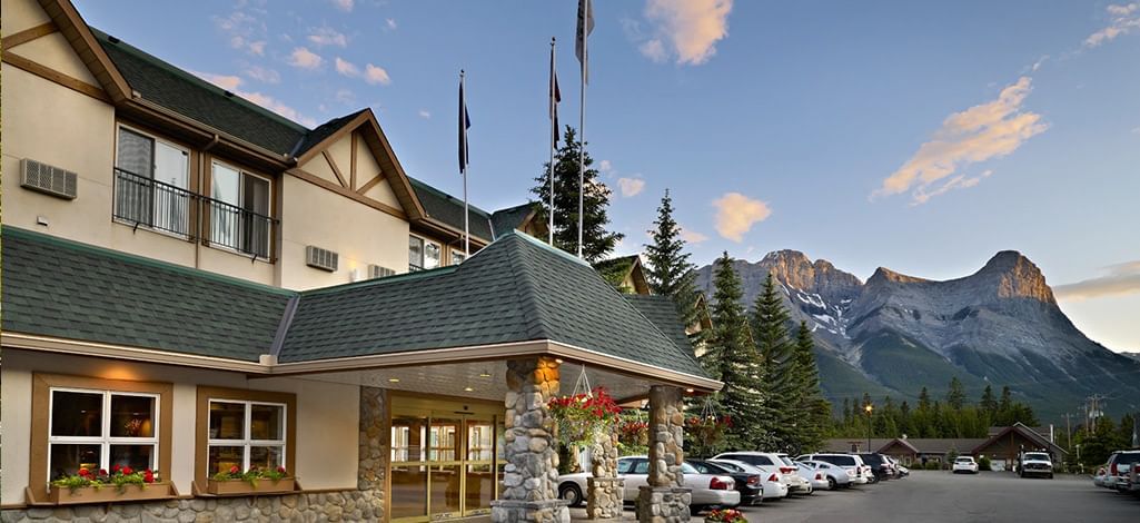 The Coast Canmore Hotel & Conference Centre with the mountains in the backdrop.