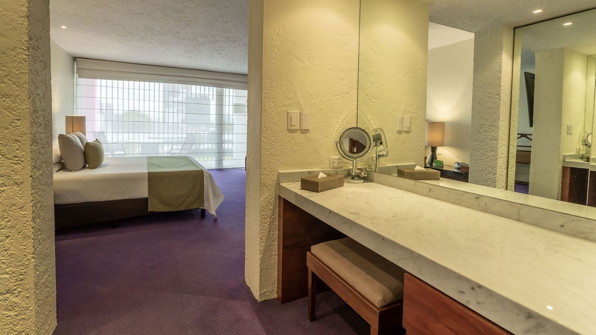 King Viceroys Suite vanity desk featuring a lighted makeup mirror and a view into the room at Camino Real Polanco Mexico