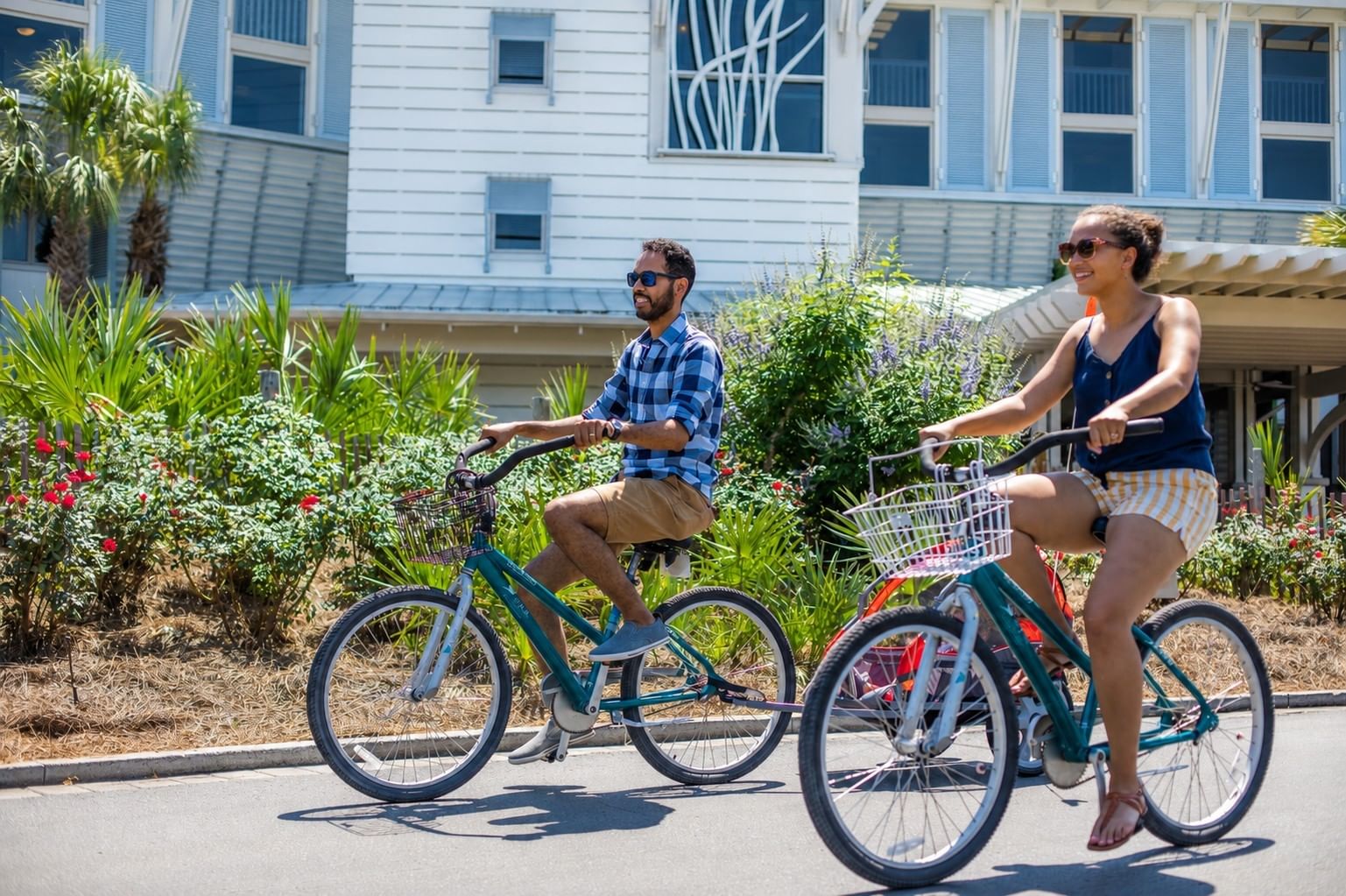 Couple Riding Bikes in front of WaterColor Inn