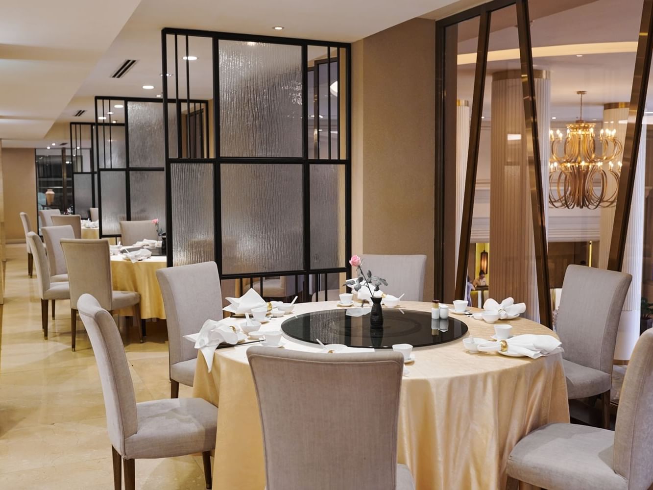 Tung Garden with round and square tables, beige chairs, and chic decor at Eastin Grand Hotel Sathorn 